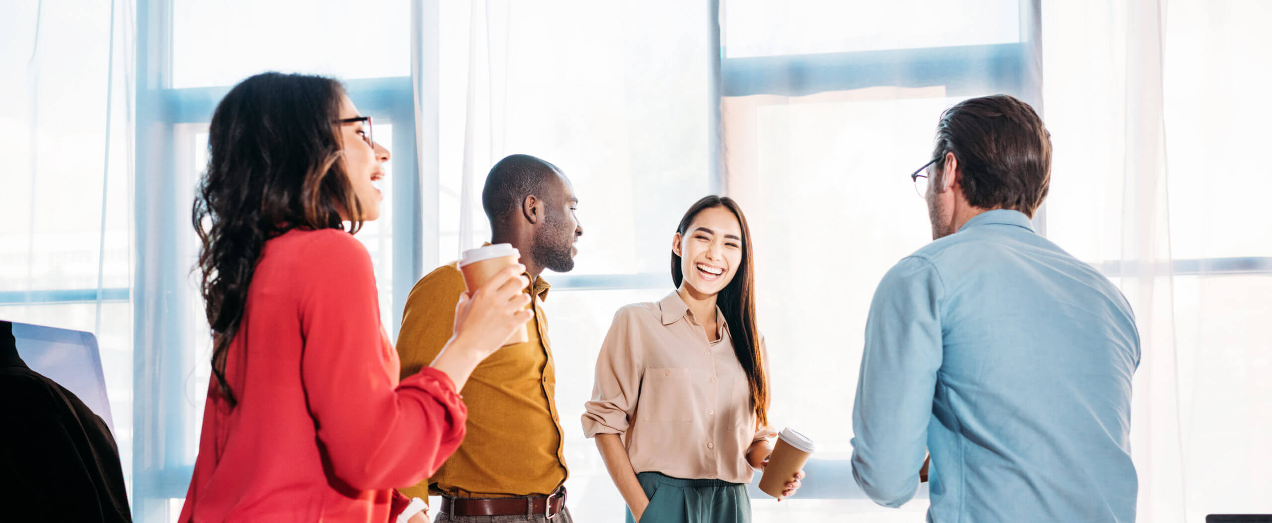 interracial business colleagues having conversation during coffe