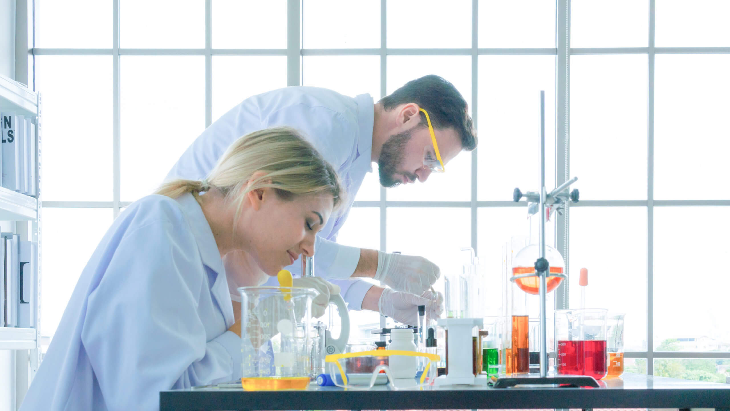 group of people scientist holding a tube with liquid substance.