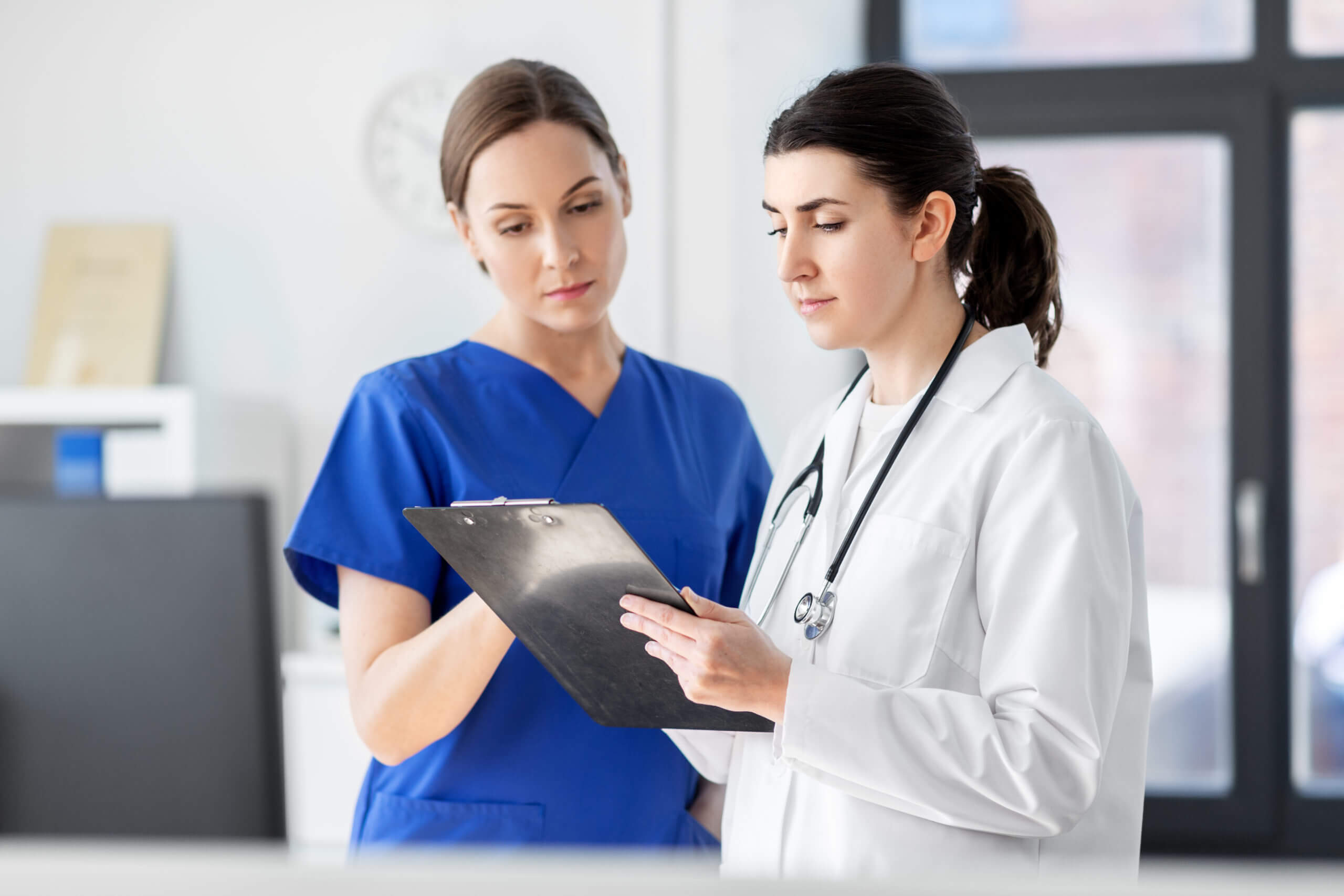doctor and nurse with clipboard at hospital