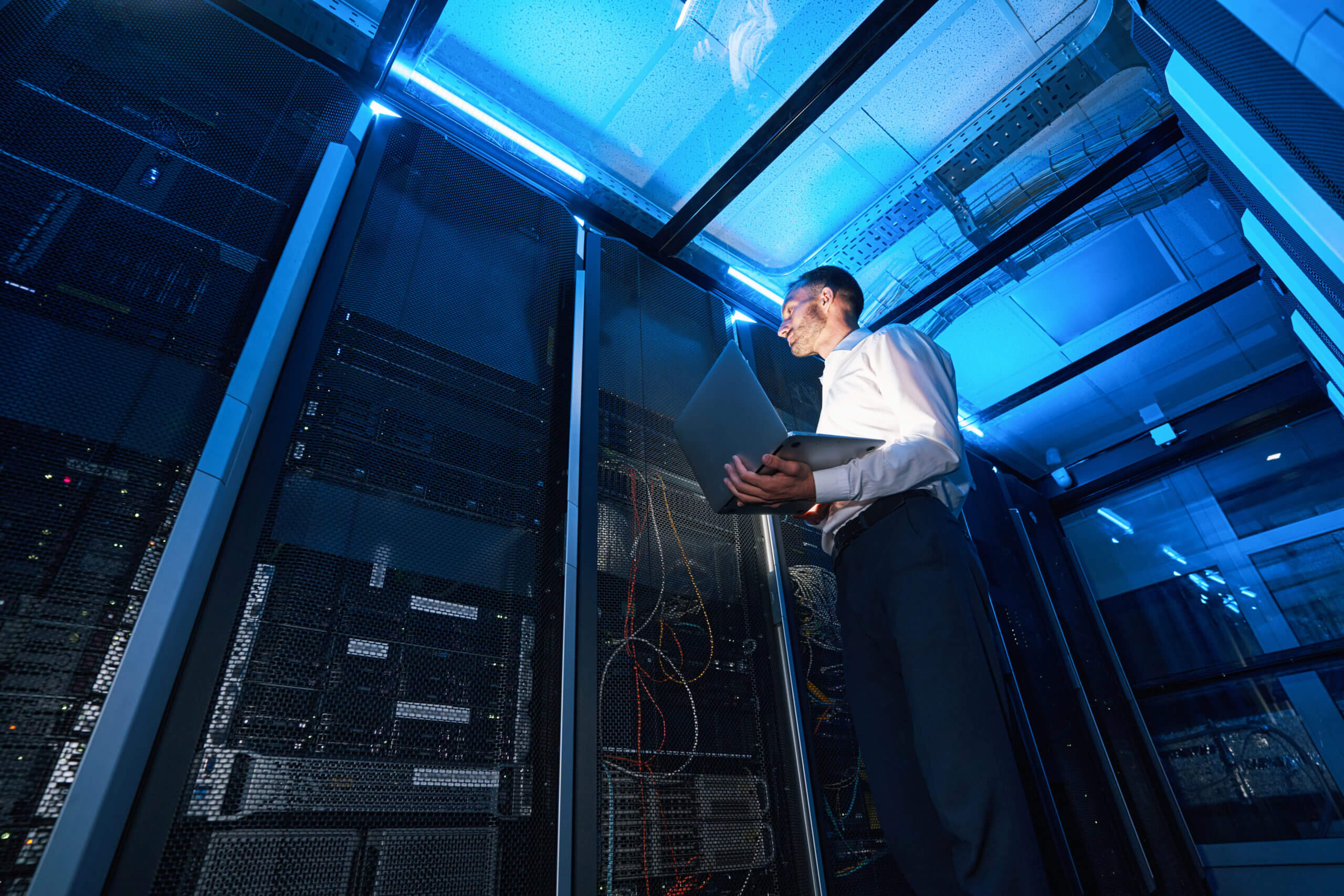 System administrator watching equipment inside erver cabinet