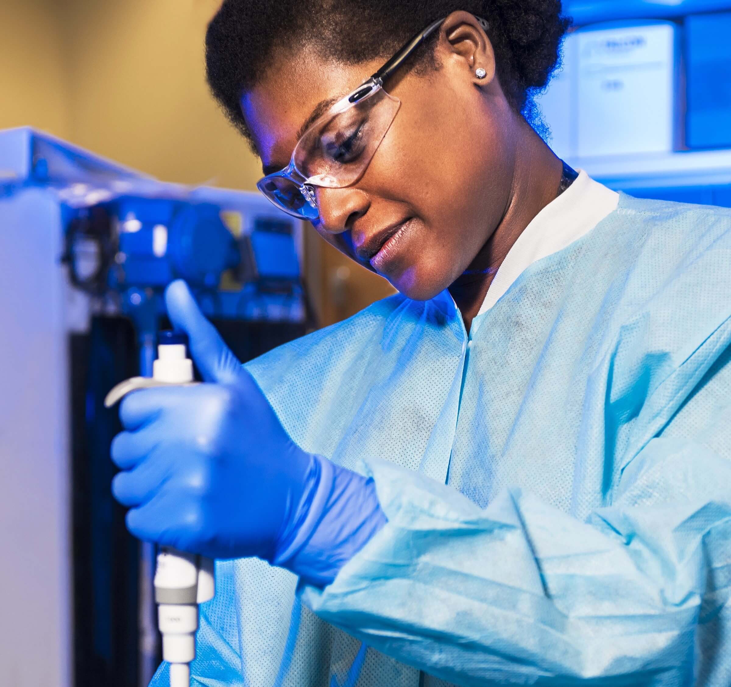 Woman working in a medical facility with a medical device