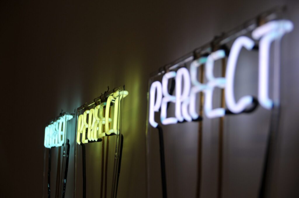 Wall art with "perfectionism" written on