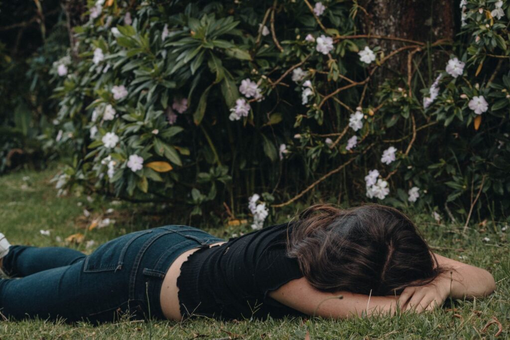 A lady lay on the floor, exhausted and experiencing burnout