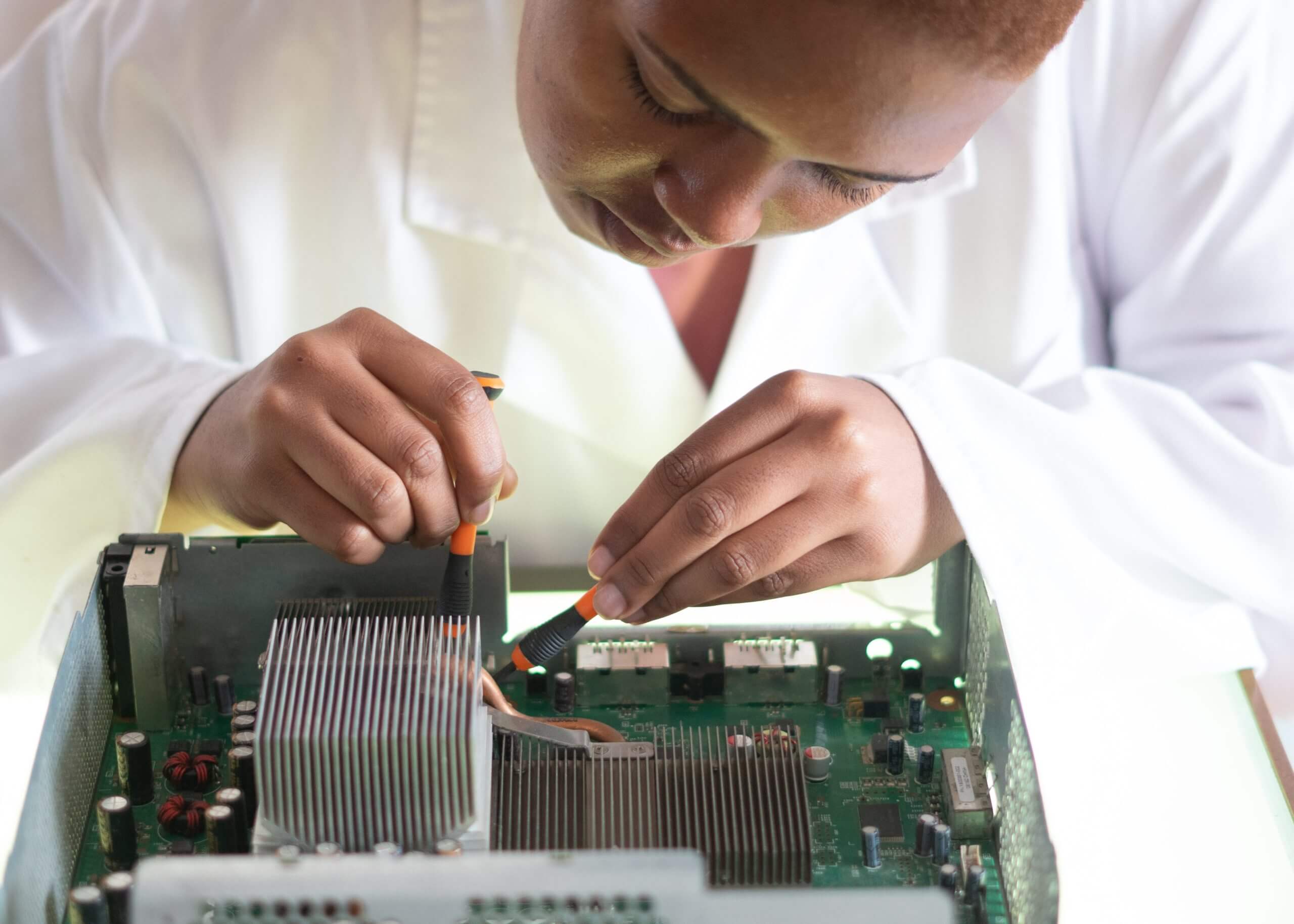 woman assembling printed circuit board