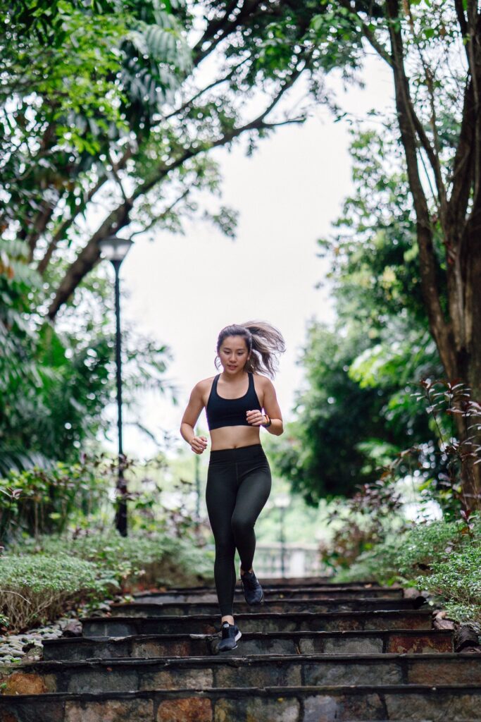 Woman running down stairs to become fit and to reach full potential