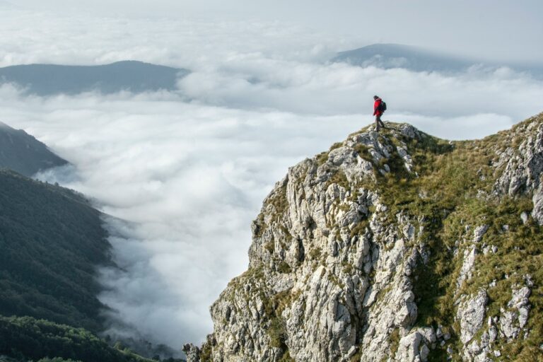 Man on mountain with valley below