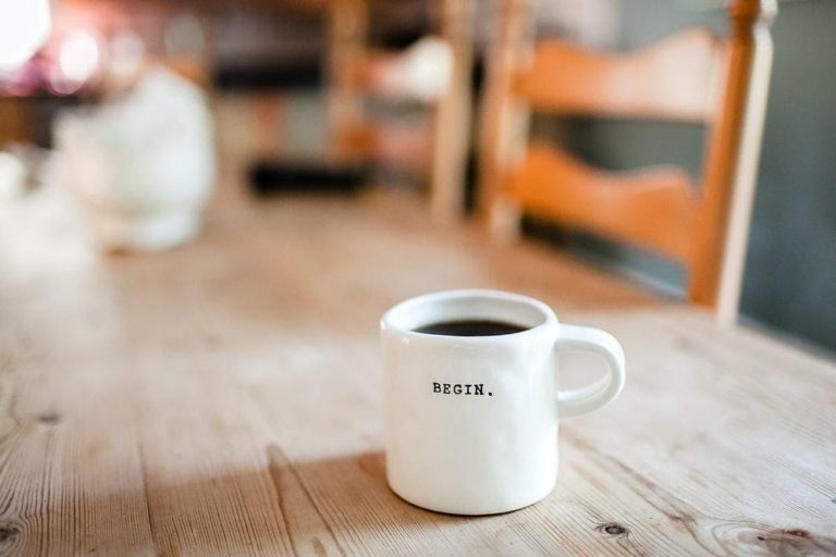 Decorative coffee cup with "Begin" written on