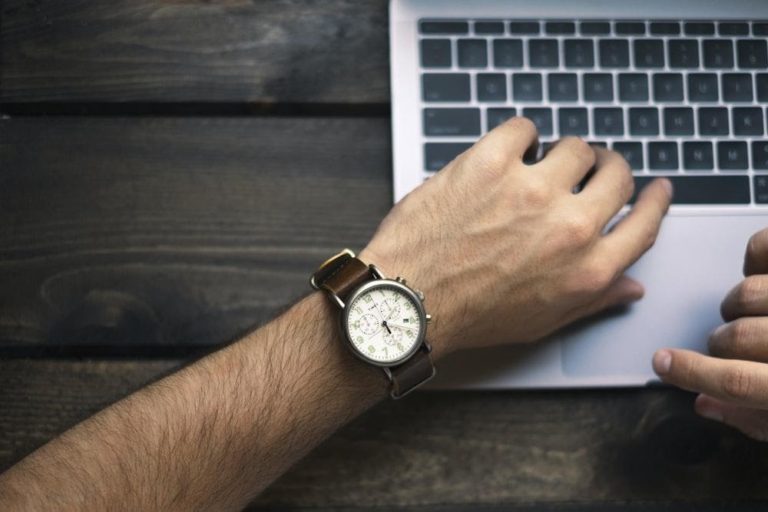 A picture of a wrist watch resting on a laptop